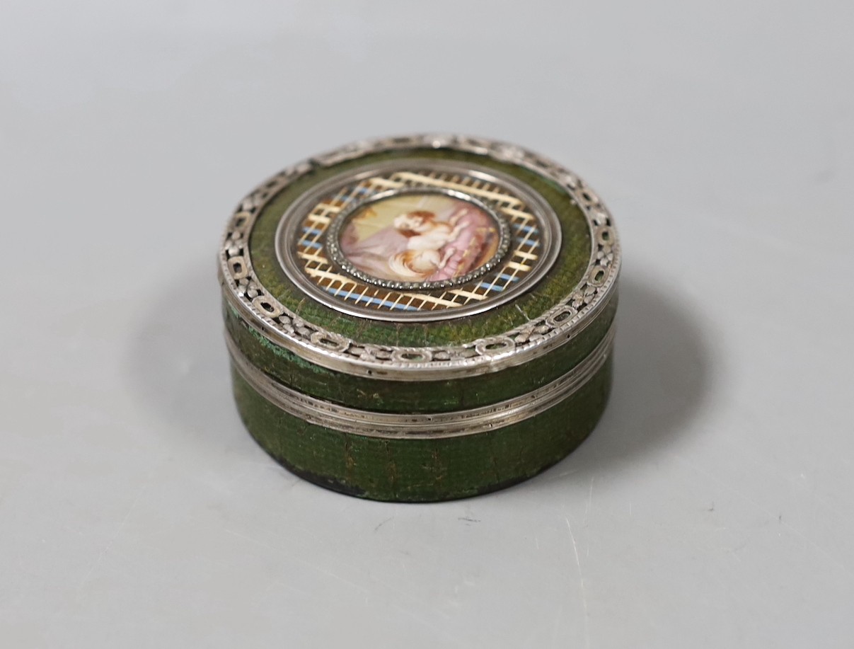 A 19th century King Charles Spaniel miniature inset into a leather and silver mounted tortoiseshell interior box. 6.5cm diameter